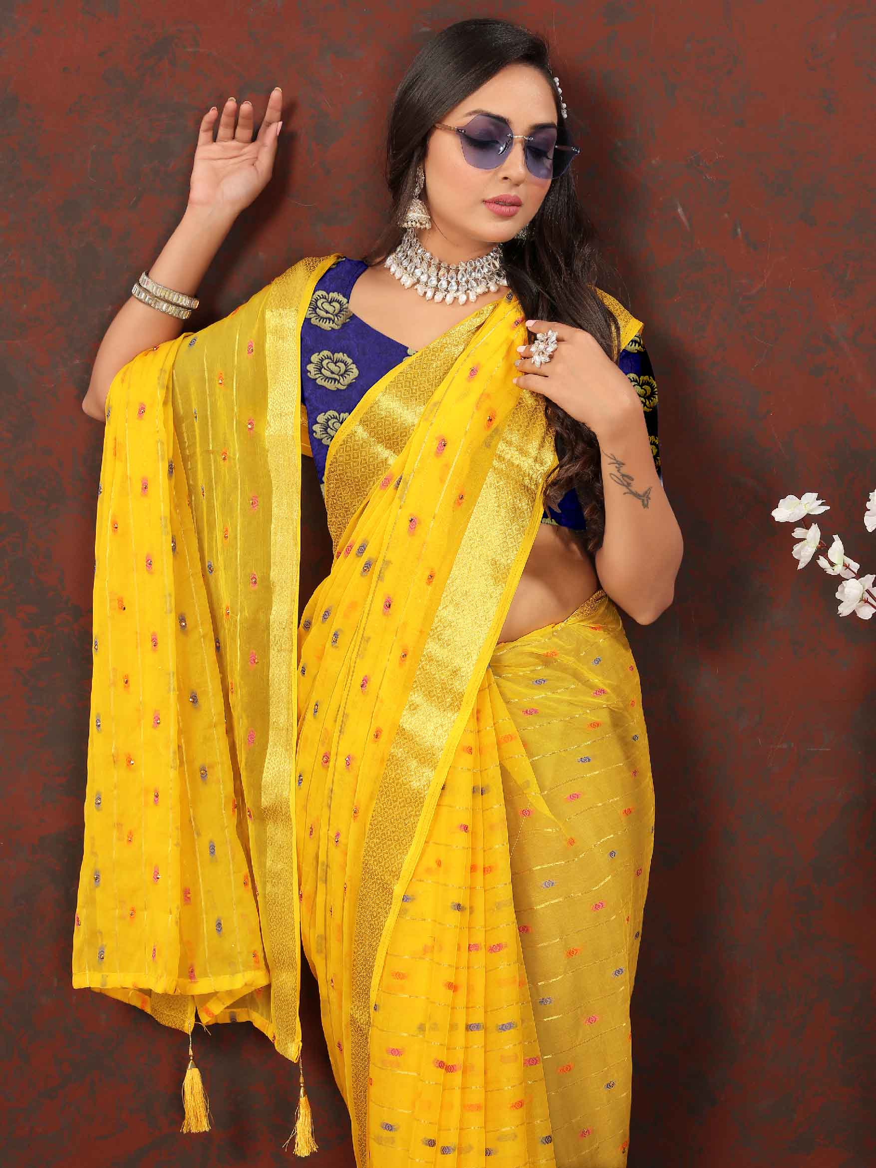 Glamorous Women's Party Wear Yellow Chiffon Saree with Woven Stripe Zari Border and Tassels - Elevate your look with this stunning ensemble! Perfect for special occasions, this saree boasts intricate zari detailing and playful tassels for a touch of elegance. Stand out and make a statement in this luxurious saree. Don't miss the chance to add this timeless piece to your wardrobe and shine bright at any event