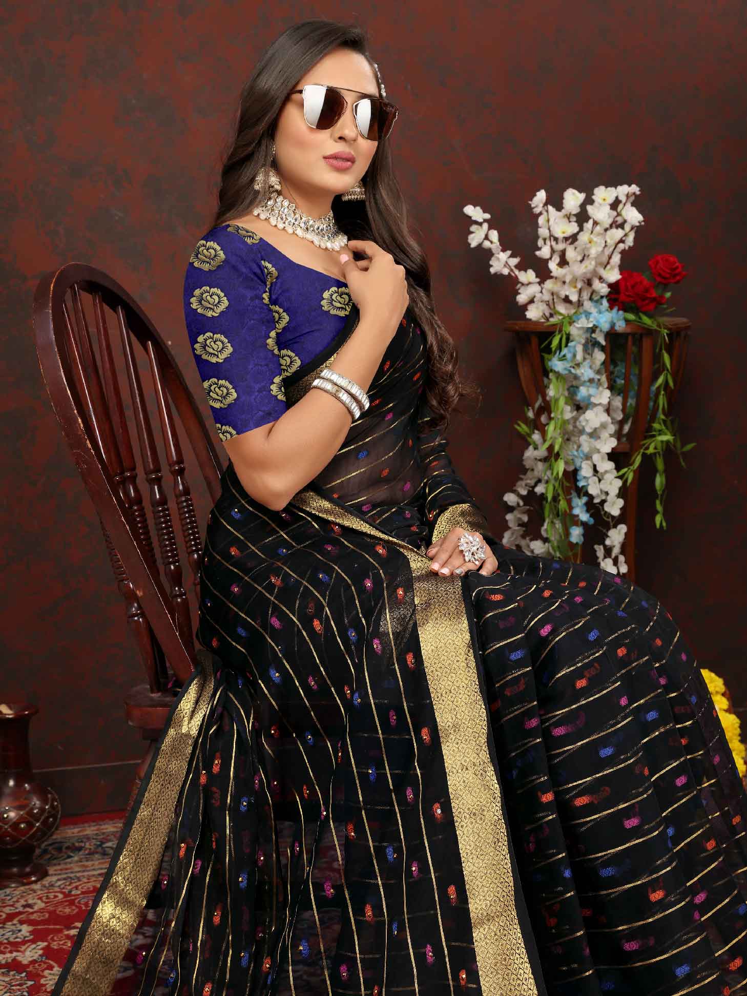 Elegant Women's Party Wear Black Chiffon Saree with Woven Stripe Zari Border and Tassels - Make a statement with this stunning ensemble! Perfect for special occasions, this saree features intricate zari detailing and playful tassels for a touch of glamour. Elevate your style and stand out from the crowd in this luxurious saree. Don't miss out on adding this timeless piece to your wardrobe!