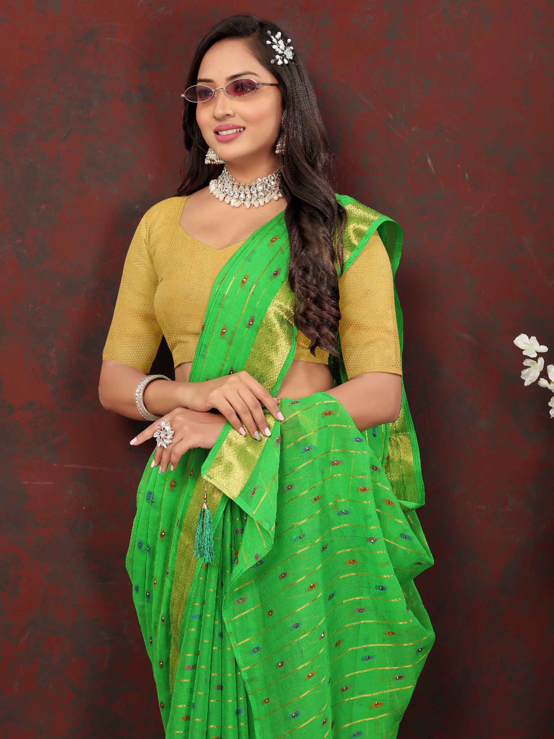 Chic Women's Party Wear Green Chiffon Saree with Woven Stripe Zari Border and Tassels - Elevate your style with this stunning ensemble! Perfect for special occasions, this saree features intricate zari detailing and playful tassels for a touch of elegance. Stand out from the crowd and make a statement in this luxurious saree. Don't miss out on adding this timeless piece to your wardrobe