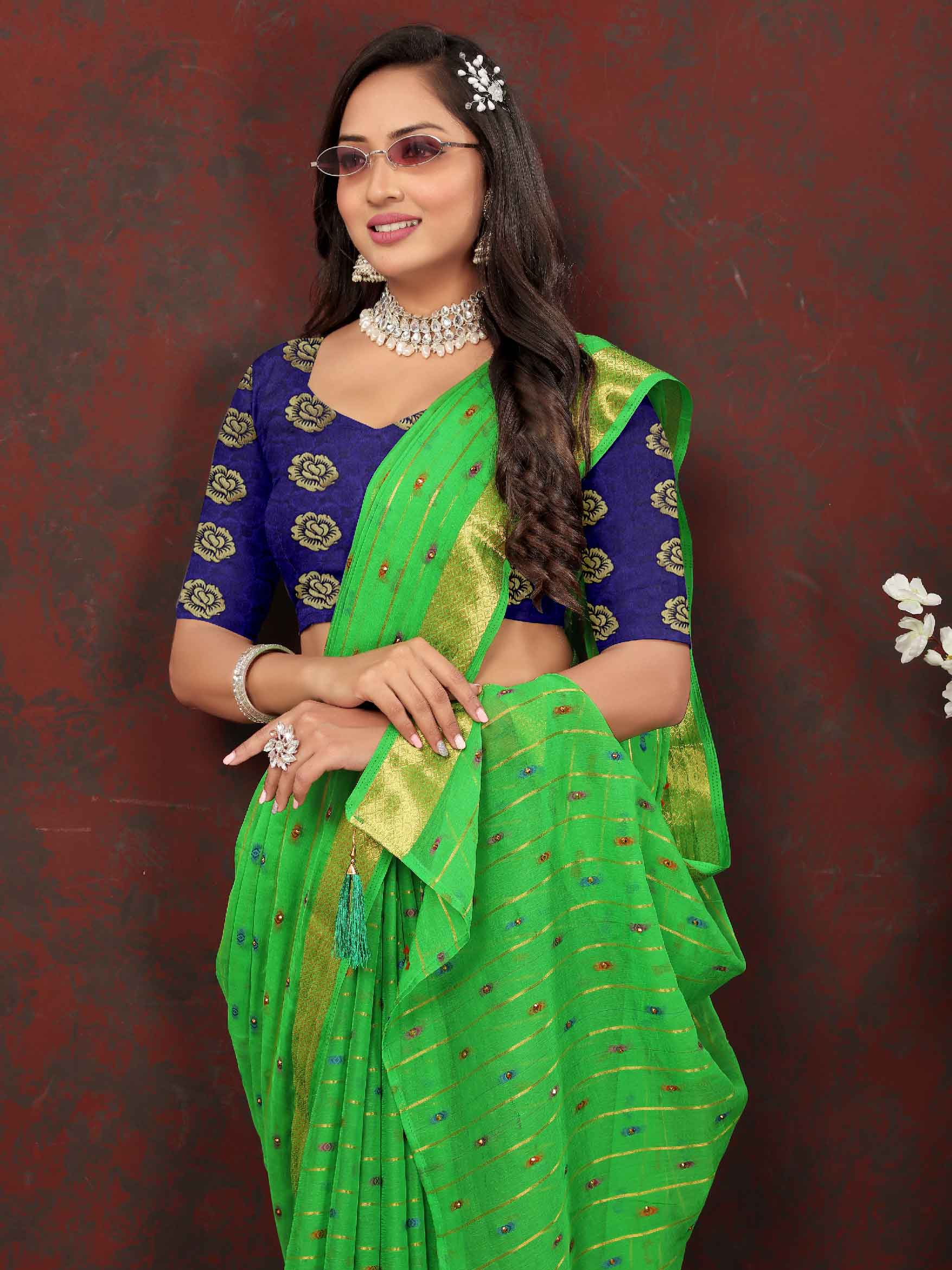 Chic Women's Party Wear Green Chiffon Saree with Woven Stripe Zari Border and Tassels - Elevate your style with this stunning ensemble! Perfect for special occasions, this saree features intricate zari detailing and playful tassels for a touch of elegance. Stand out from the crowd and make a statement in this luxurious saree. Don't miss out on adding this timeless piece to your wardrobe