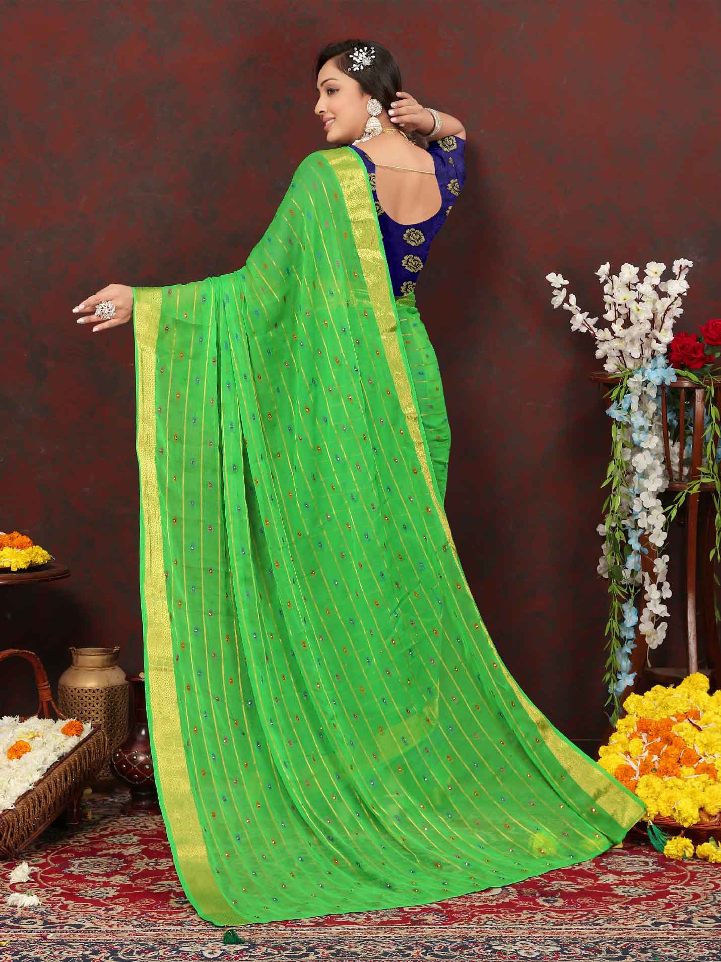 Chic Women's Party Wear Green Chiffon Saree with Woven Stripe Zari Border and Tassels - Elevate your style with this stunning ensemble! Perfect for special occasions, this saree features intricate zari detailing and playful tassels for a touch of elegance. Stand out from the crowd and make a statement in this luxurious saree. Don't miss out on adding this timeless piece to your wardrobe