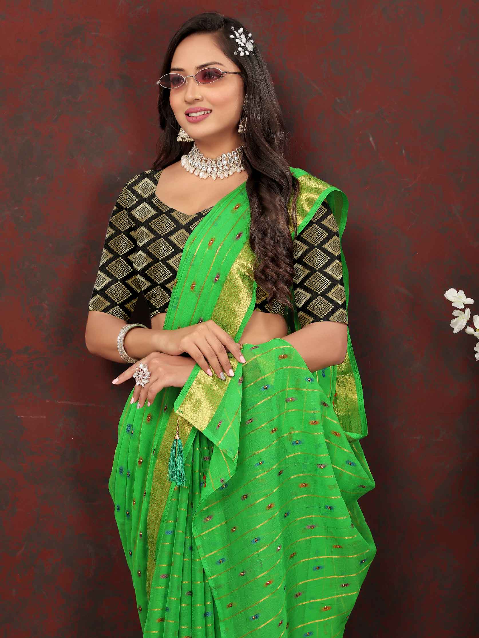 Chic Women's Party Wear Green Chiffon Saree with Woven Stripe Zari Border and Tassels - Elevate your style with this stunning ensemble! Perfect for special occasions, this saree features intricate zari detailing and playful tassels for a touch of elegance. Stand out from the crowd and make a statement in this luxurious saree. Don't miss out on adding this timeless piece to your wardrobe